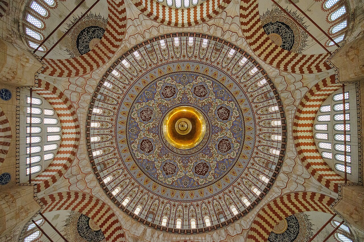 The painted interior of the Selimiye Mosque's great dome, ringed with windows, seen from the prayer hall floor