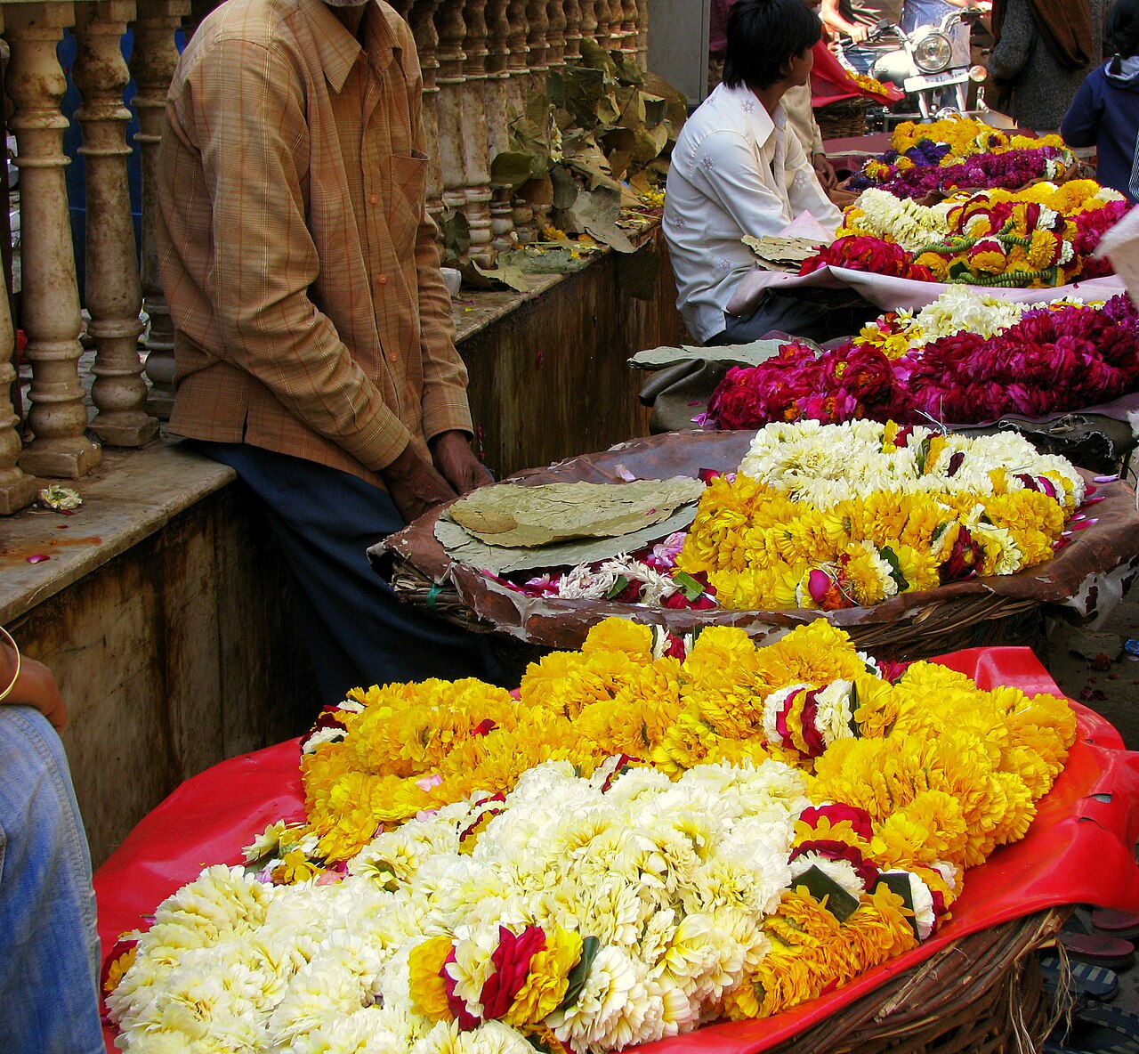 Garland sellers with baskets of marigold and rose in the lane outside Shri Banke Bihari Mandir, Vrindavan