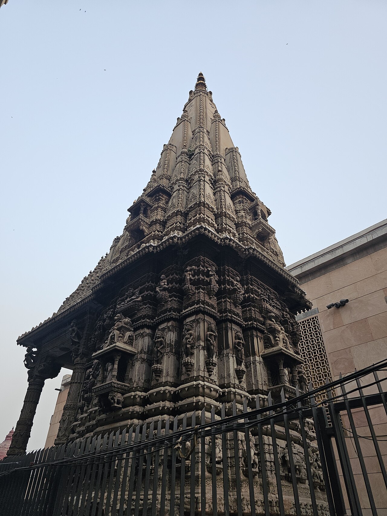 Carved stone shikhara rising within the Shri Kashi Vishwanath temple complex, Varanasi