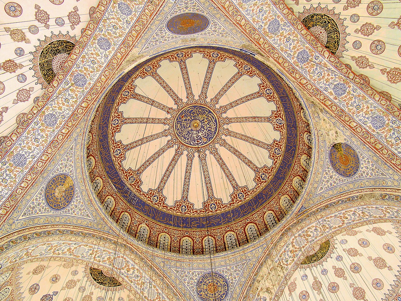 The painted central dome and pendentives of the Sultan Ahmed Mosque, ringed by windows above the blue İznik tilework