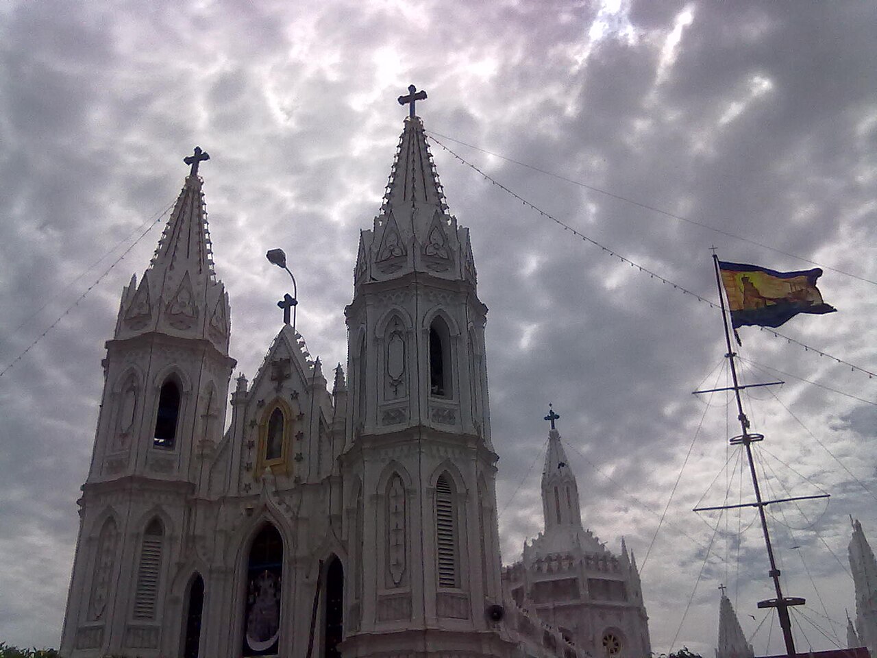 The festival flag flying on its mast before the spires of the basilica during the annual feast