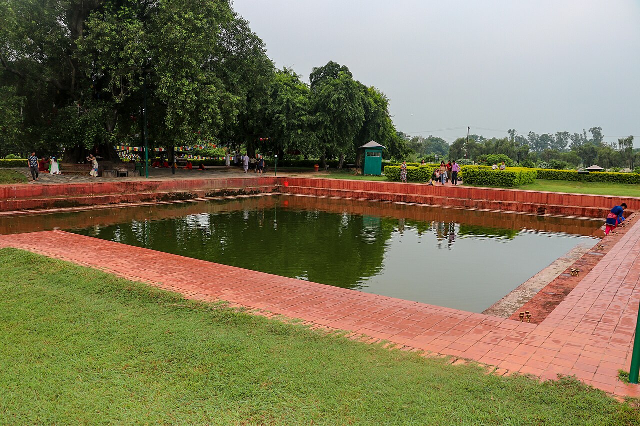 The Puskarini, the sacred pond where tradition says Queen Maya Devi bathed before the birth of the Buddha, with the Bodhi tree beside it