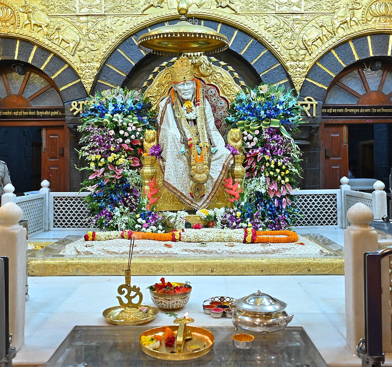 The samadhi and marble statue of Shri Sai Baba dressed and garlanded inside the Samadhi Mandir