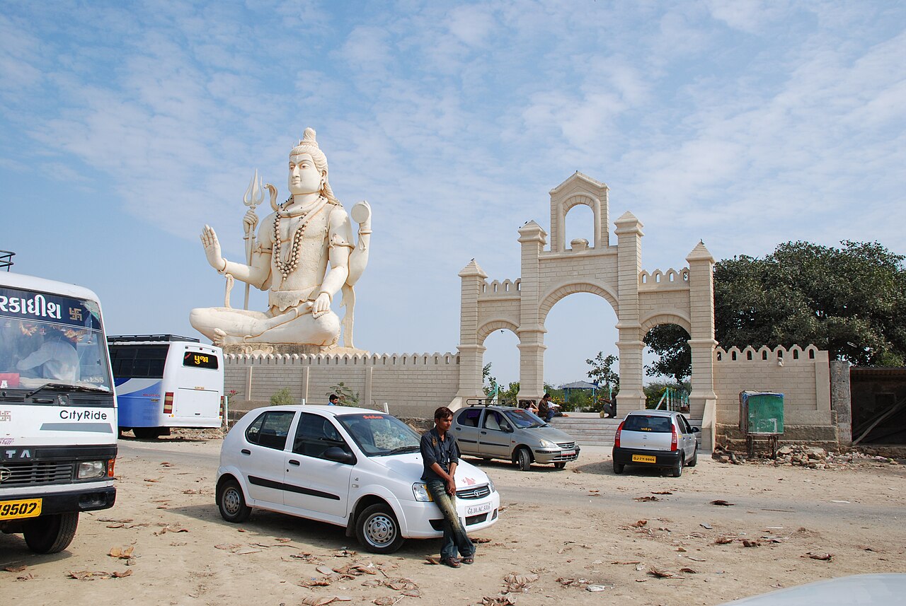 The gateway of Nageshwar temple on the Dwarka to Bet Dwarka road, the seated Lord Shiva rising behind it