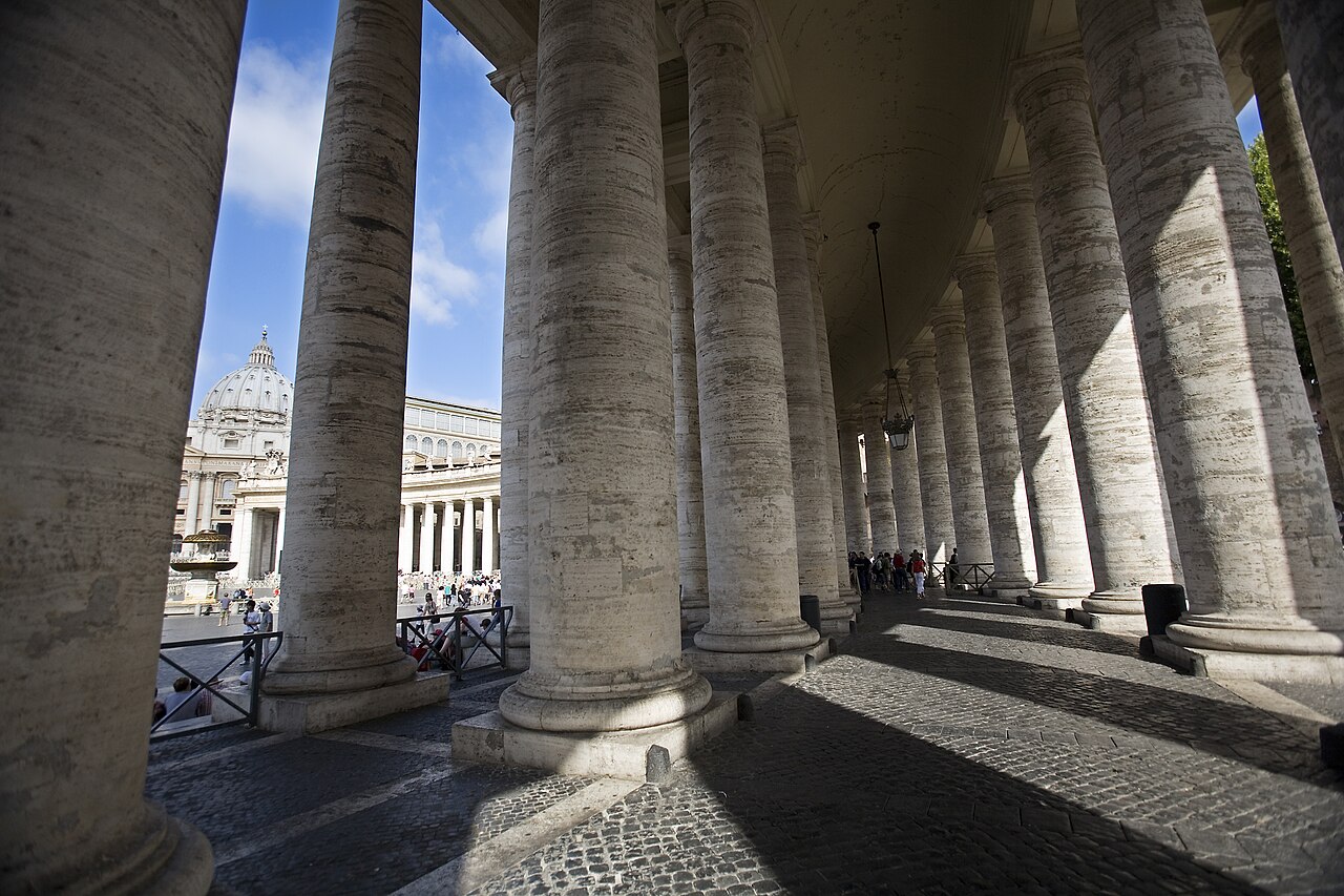 The four-deep travertine columns of Bernini's colonnade curving around St. Peter's Square