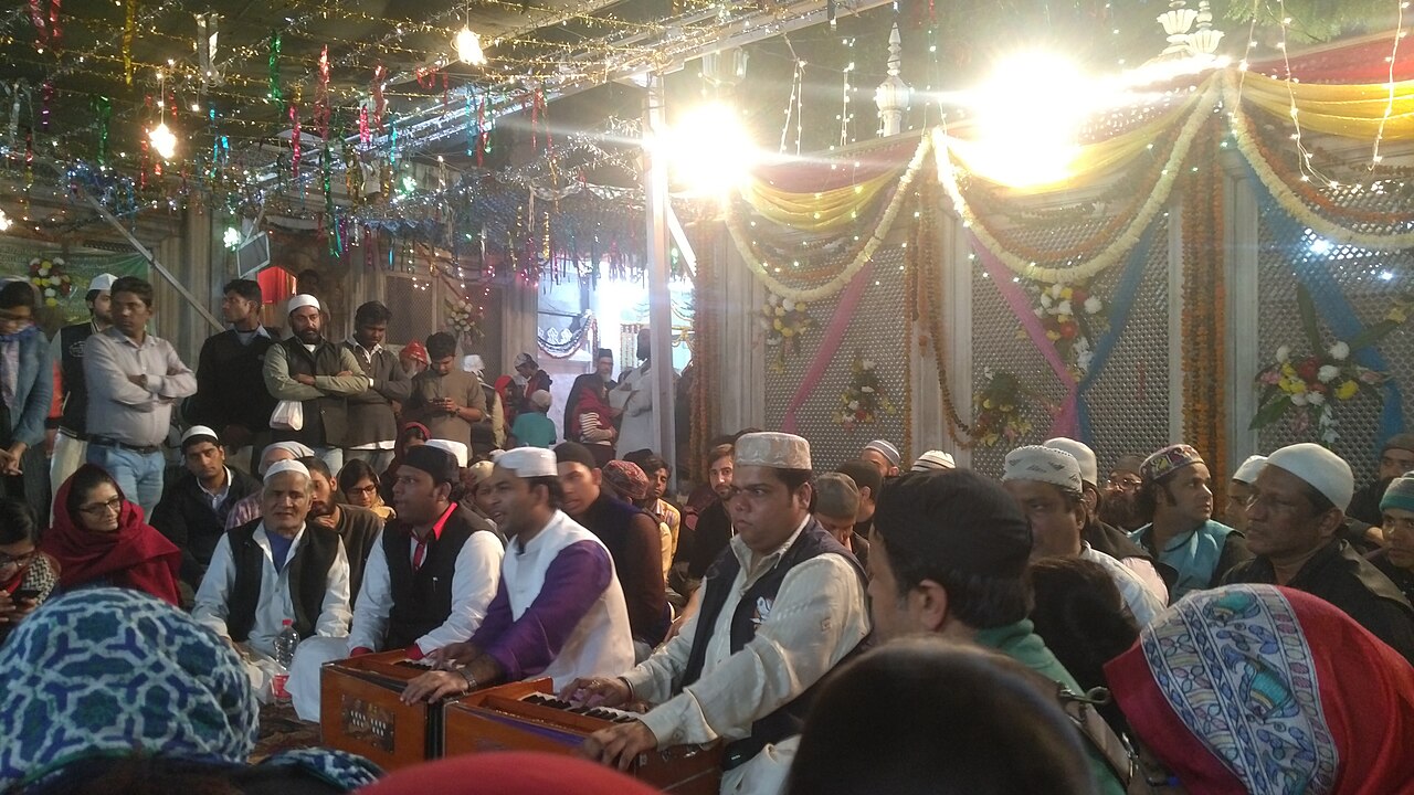 Qawwals at their harmoniums singing the evening mehfil-e-sama before the decorated mazar at Hazrat Nizamuddin Dargah