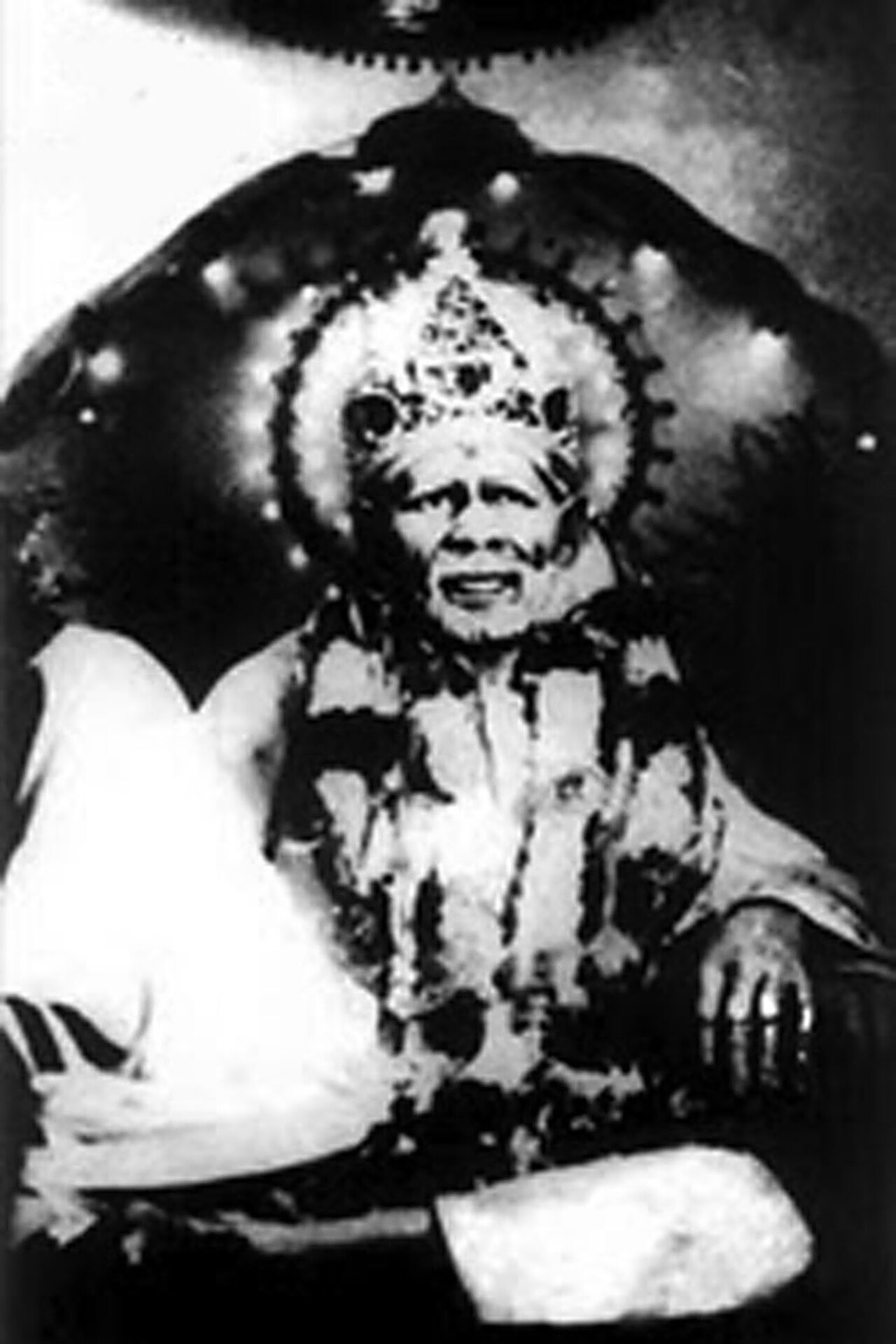 Sai Baba of Shirdi himself, photographed seated in the Chavadi wearing a crown placed by his devotees
