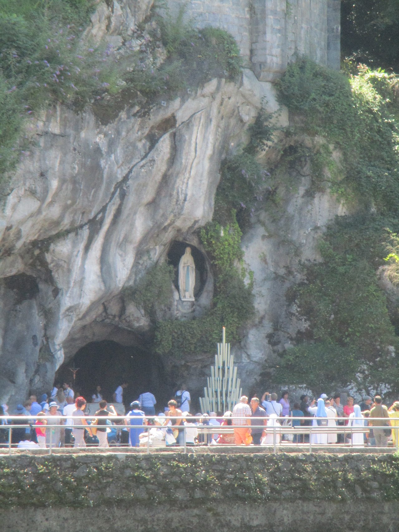 The Grotto of Massabielle with the statue of Our Lady in the niche where the apparitions took place