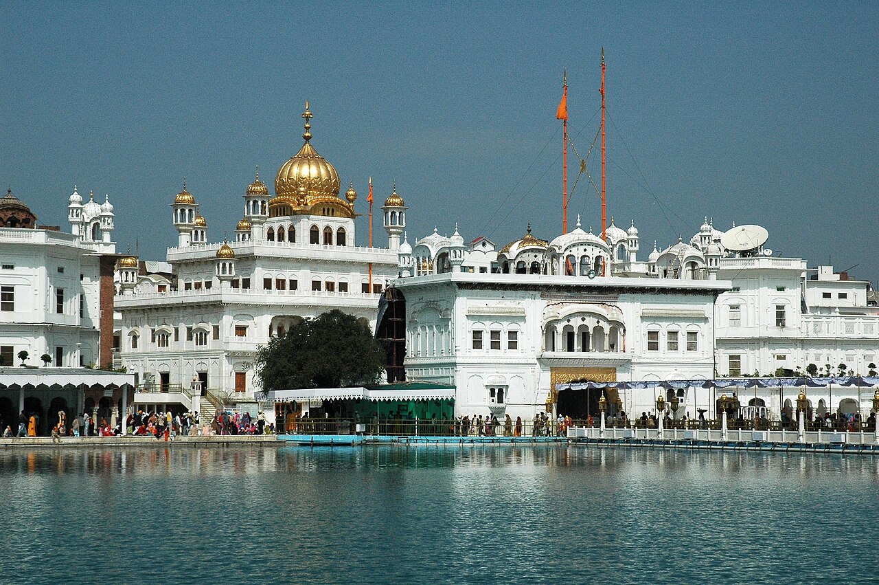 The twin Nishan Sahibs of miri and piri standing before Sri Akal Takht Sahib