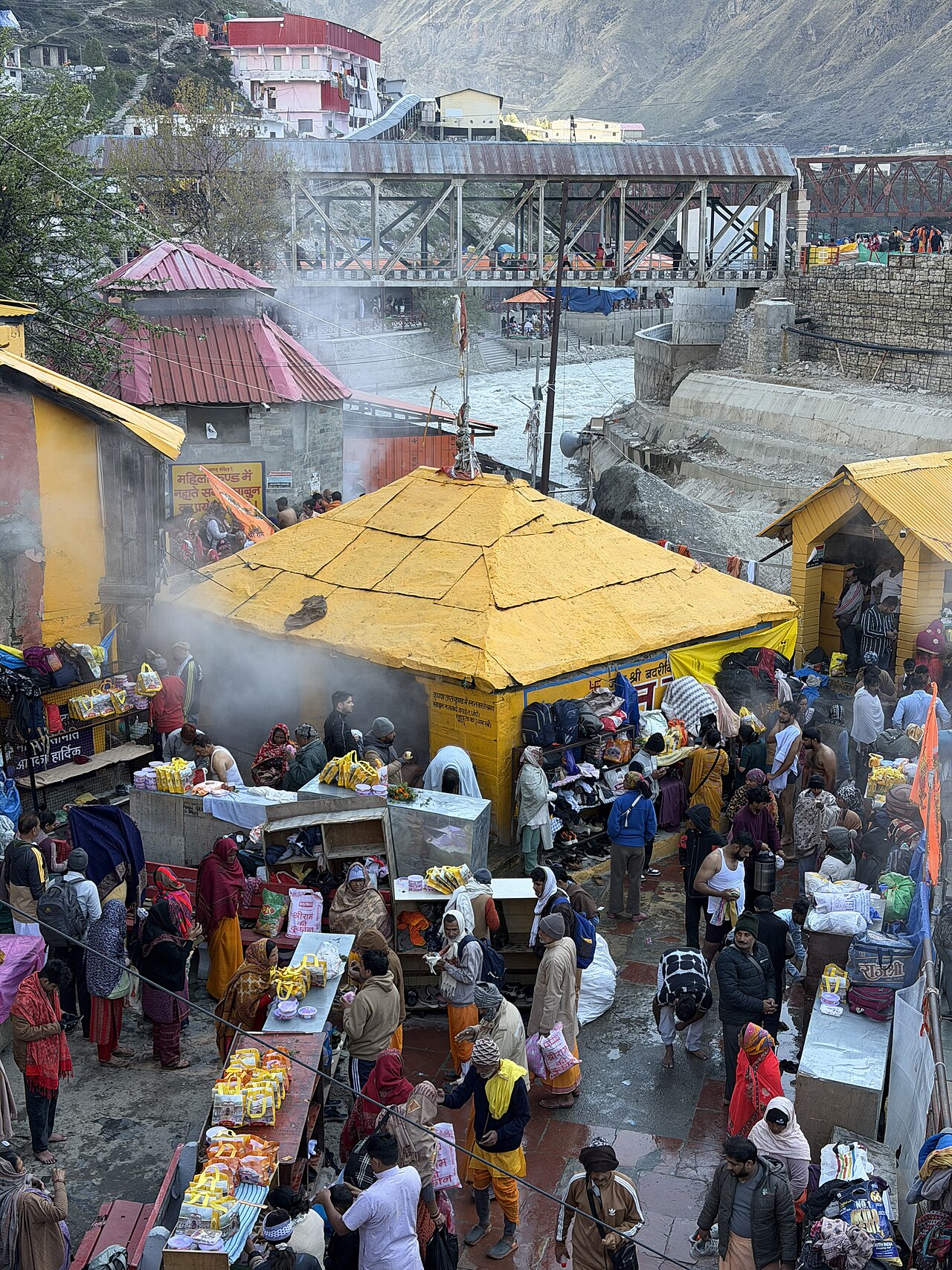 Steam rising from the Tapt Kund hot spring below Badrinath temple, where pilgrims bathe before darshan