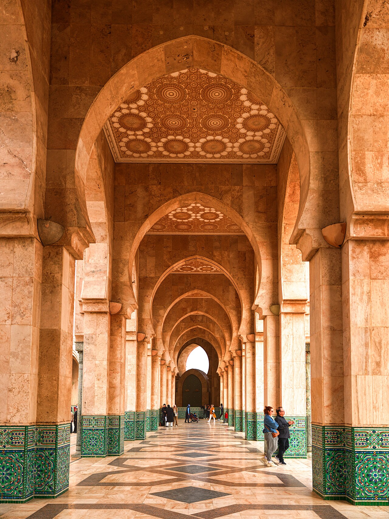 A marble corridor within the Hassan II Mosque complex, carved and tiled by Moroccan maalems