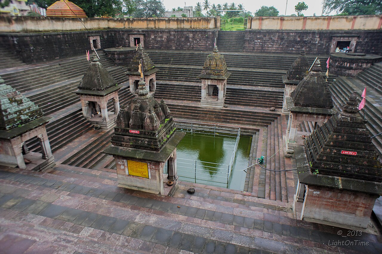 The stepped Shivalaya Tirtha tank at Verul, its water ringed by stone steps and small spired shrines