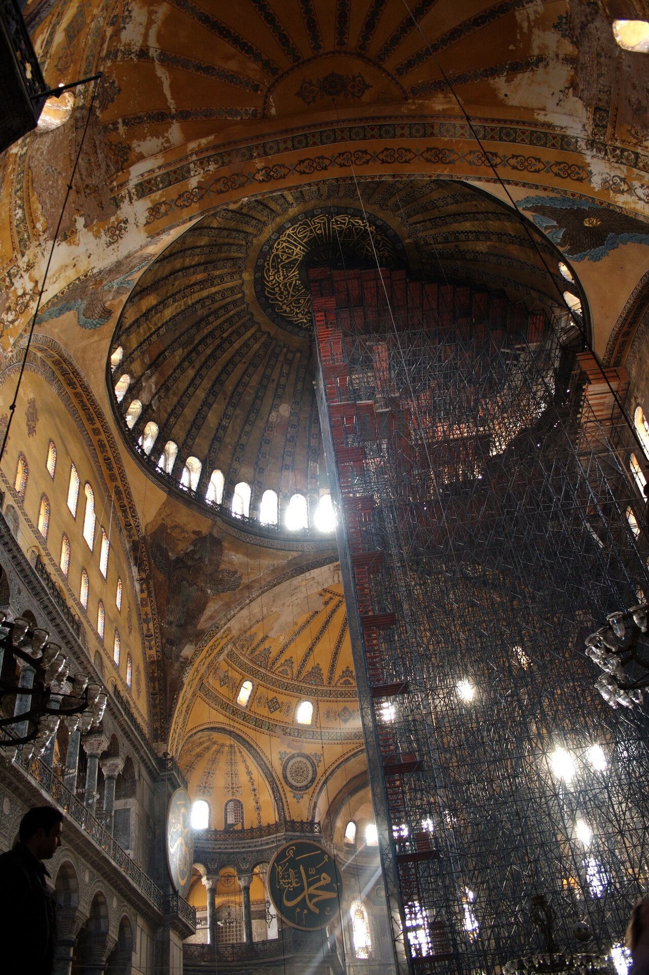 The dome of Hagia Sophia from below, its ring of windows and calligraphy roundels catching the light