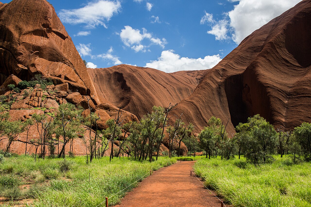 Mutitjulu Waterhole, a permanent pool at the base of Uluru ringed by pale stone and desert trees