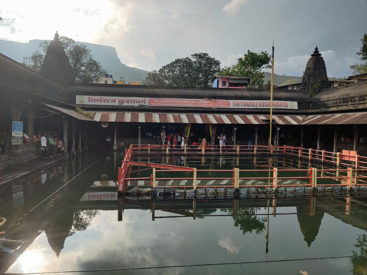 Pilgrims under the colonnade of Kushavarta Tirth, the tank where the Godavari first gathers at Trimbak
