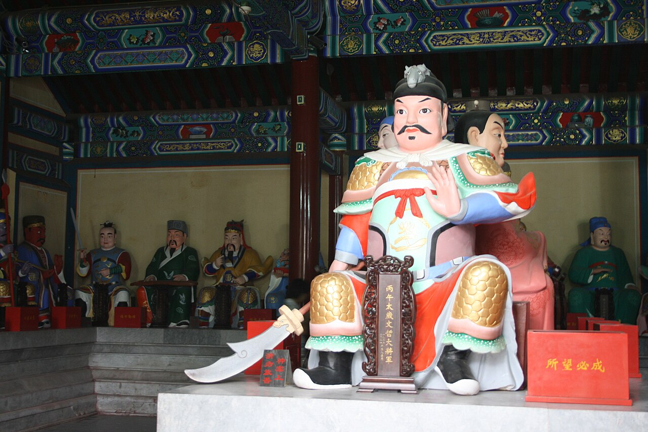Painted statues of the sixty Taisui year-generals in the Yuanchen Hall of the White Cloud Temple, an armoured general seated at the centre