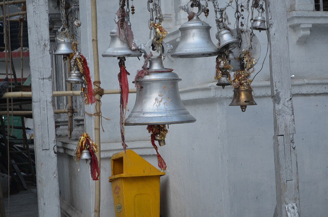 Rows of temple bells hung at Gangotri Dham, rung by passing pilgrims