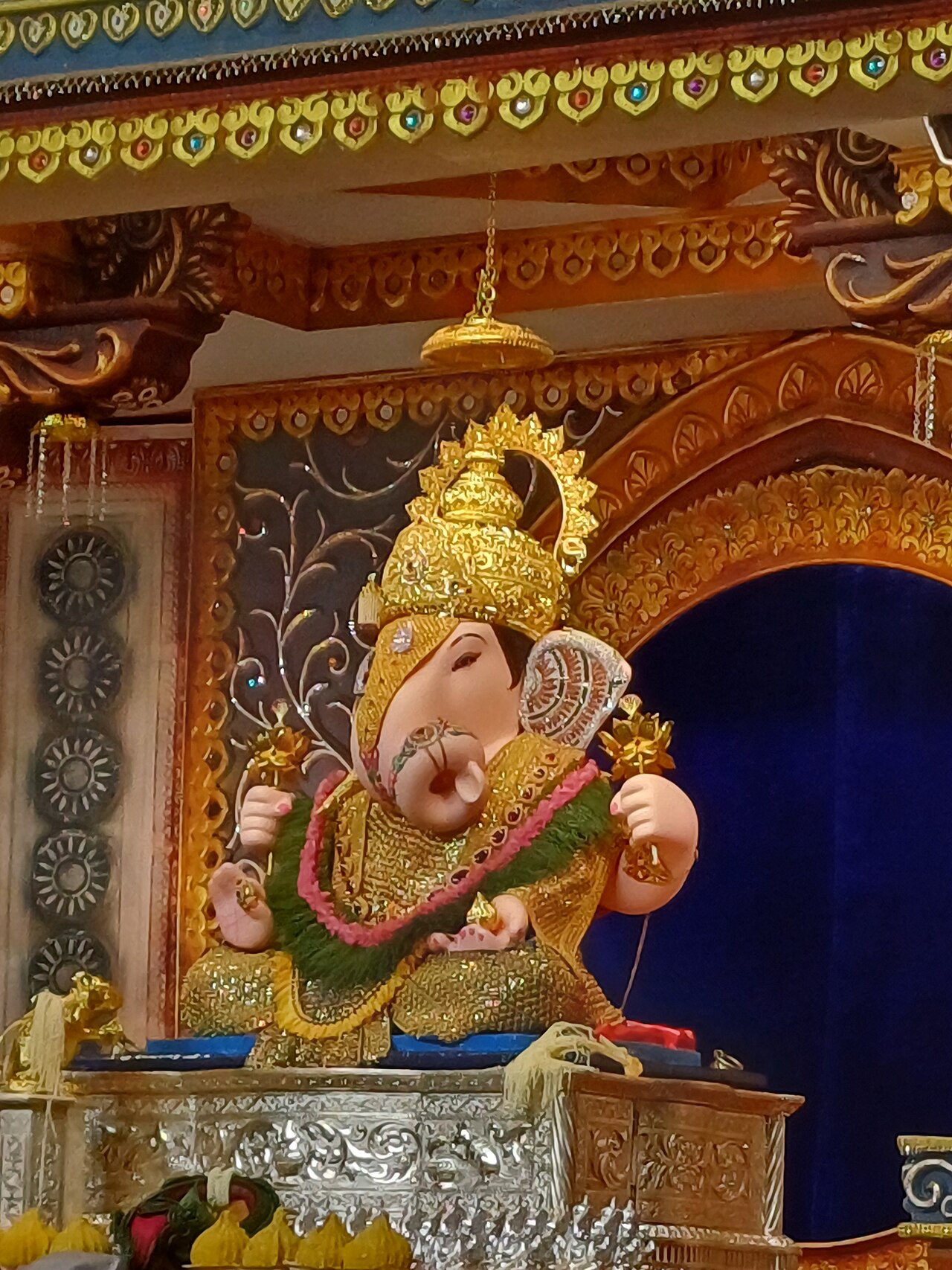 Shrimant Dagadusheth Halwai Ganapati in golden crown and shringar during the 2024 Ganeshotsav