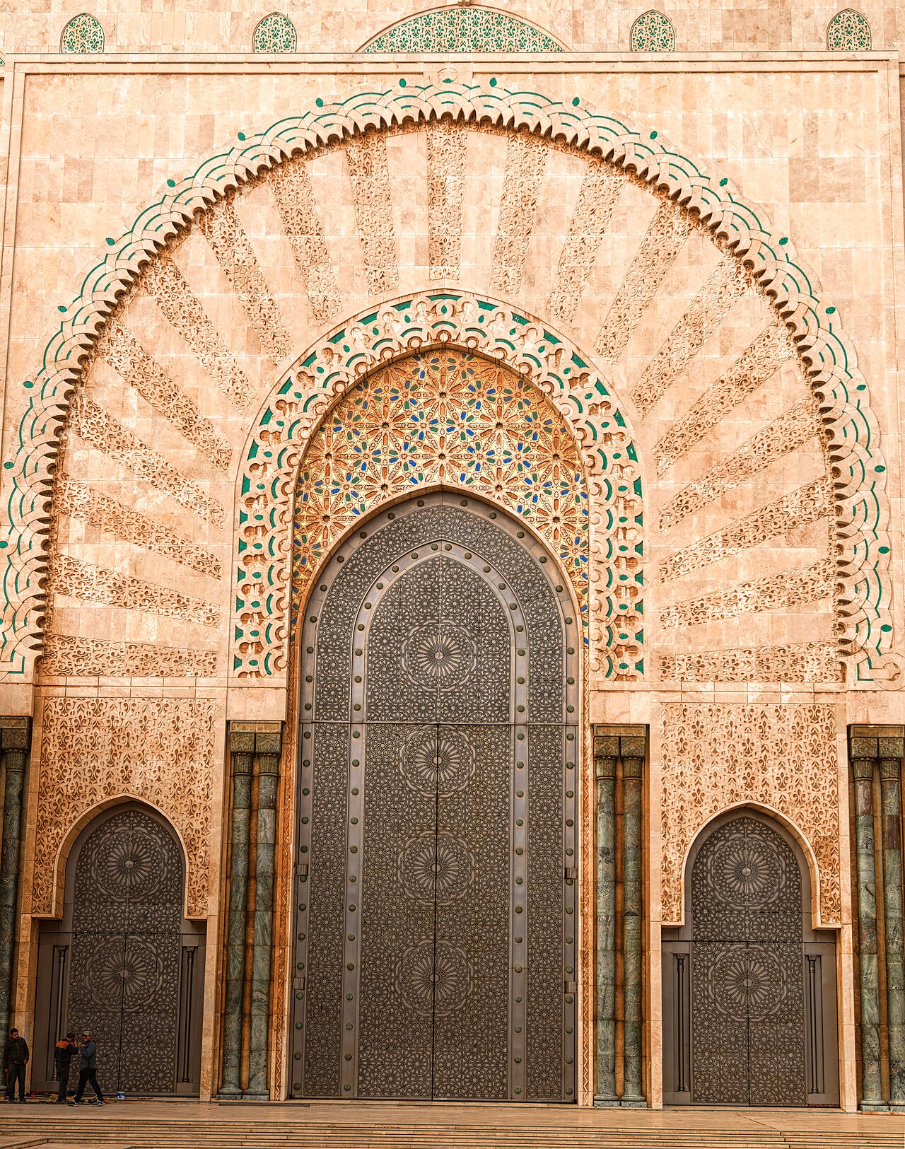 A titanium and brass entrance door at the Hassan II Mosque, set against the sea air the metal was chosen to resist