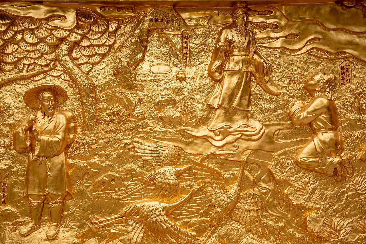 Gilded relief mural at Wong Tai Sin Temple showing the Great Immortal Wong on clouds, the shepherd's forty years of cultivation, and cranes in flight